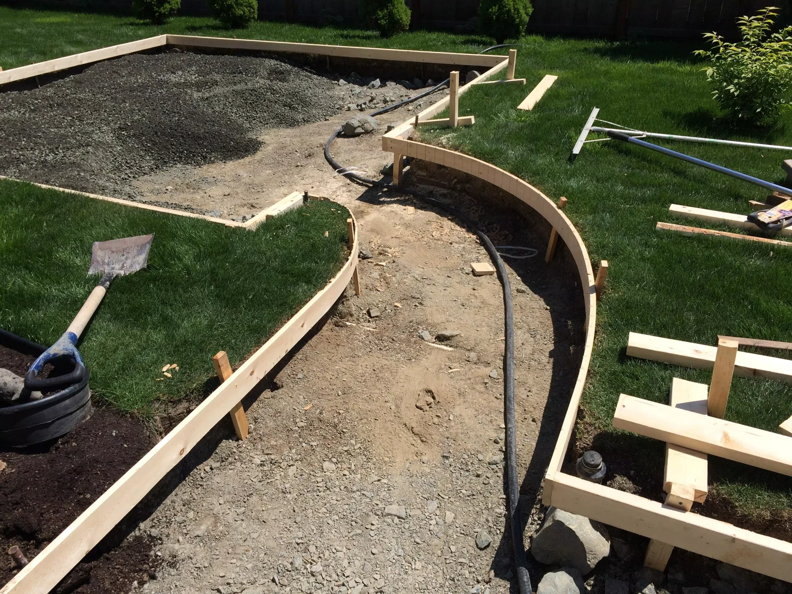 Timber formwork defining the curves of a garden path